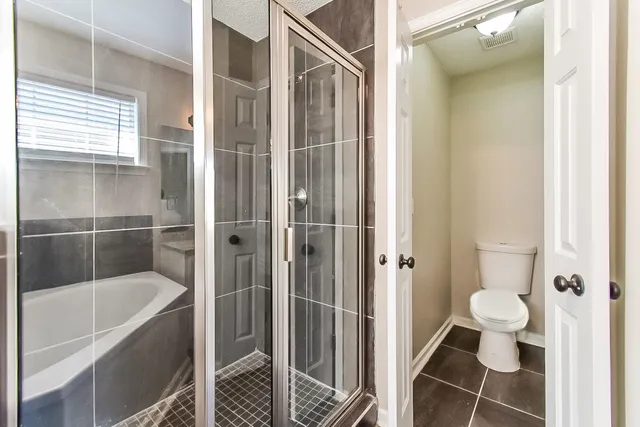 a bathroom with a bathtub and toilet