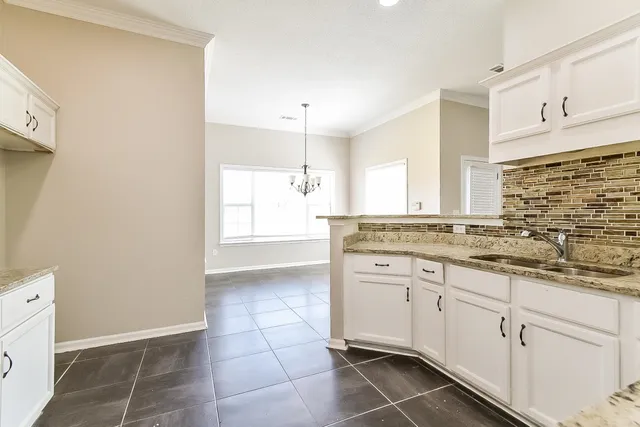 a spacious bathroom with a granite countertop sink a mirror and a