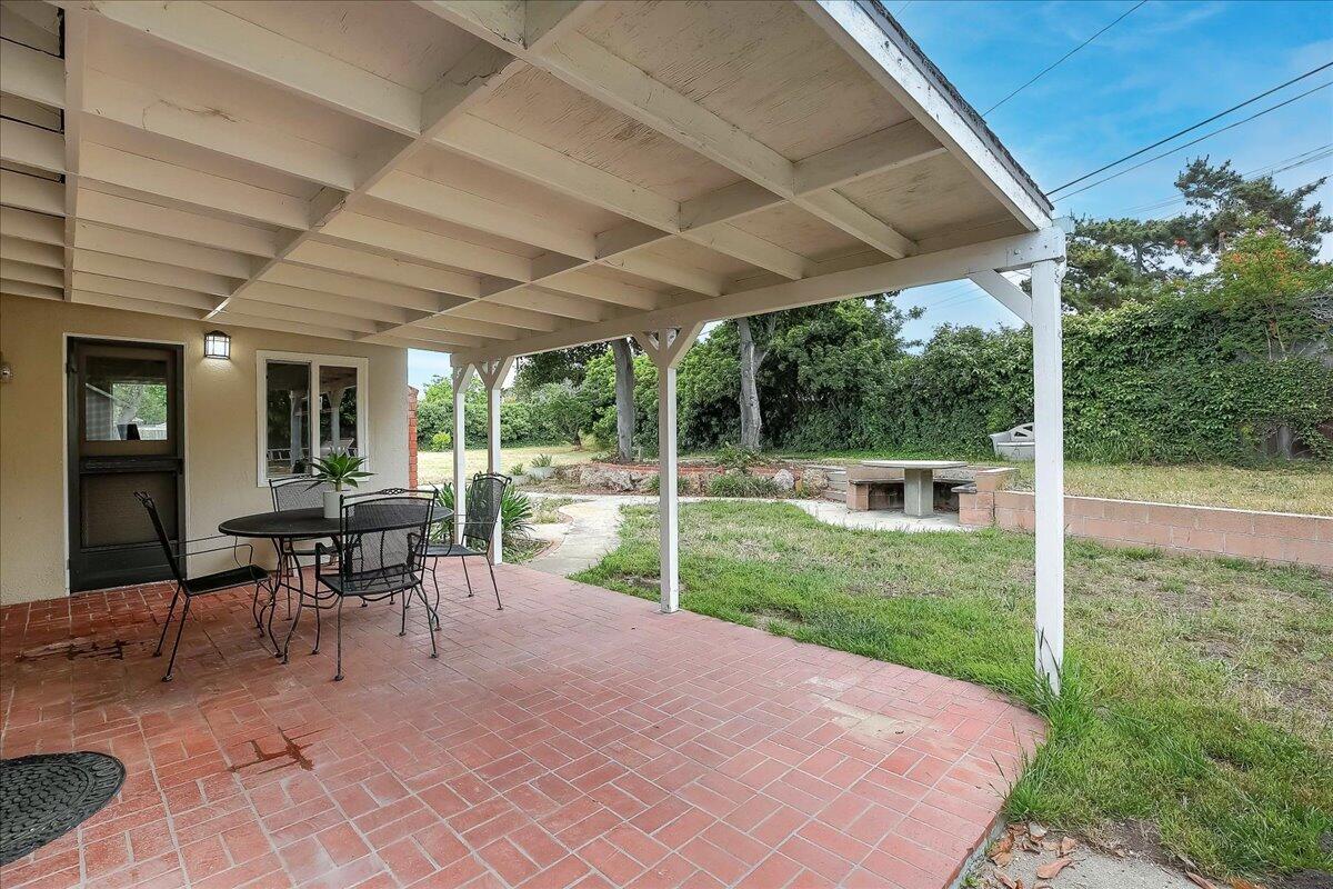 77 Newcastle Circle Goleta, CA 93117 - Photo 13 of 34 a view of a patio with a table chairs and a backyard