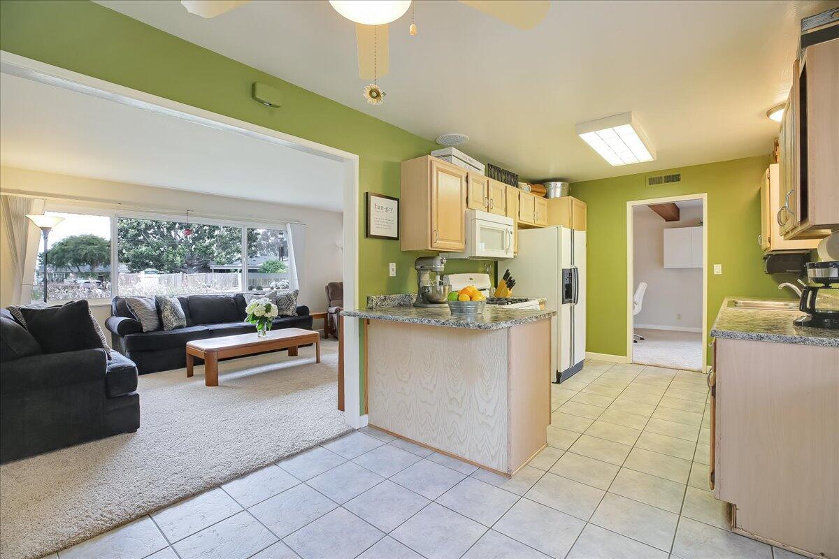 77 Newcastle Circle Goleta, CA 93117 - Photo 18 of 34 a kitchen with stainless steel appliances kitchen island granite countertop a refrigerator and a sink