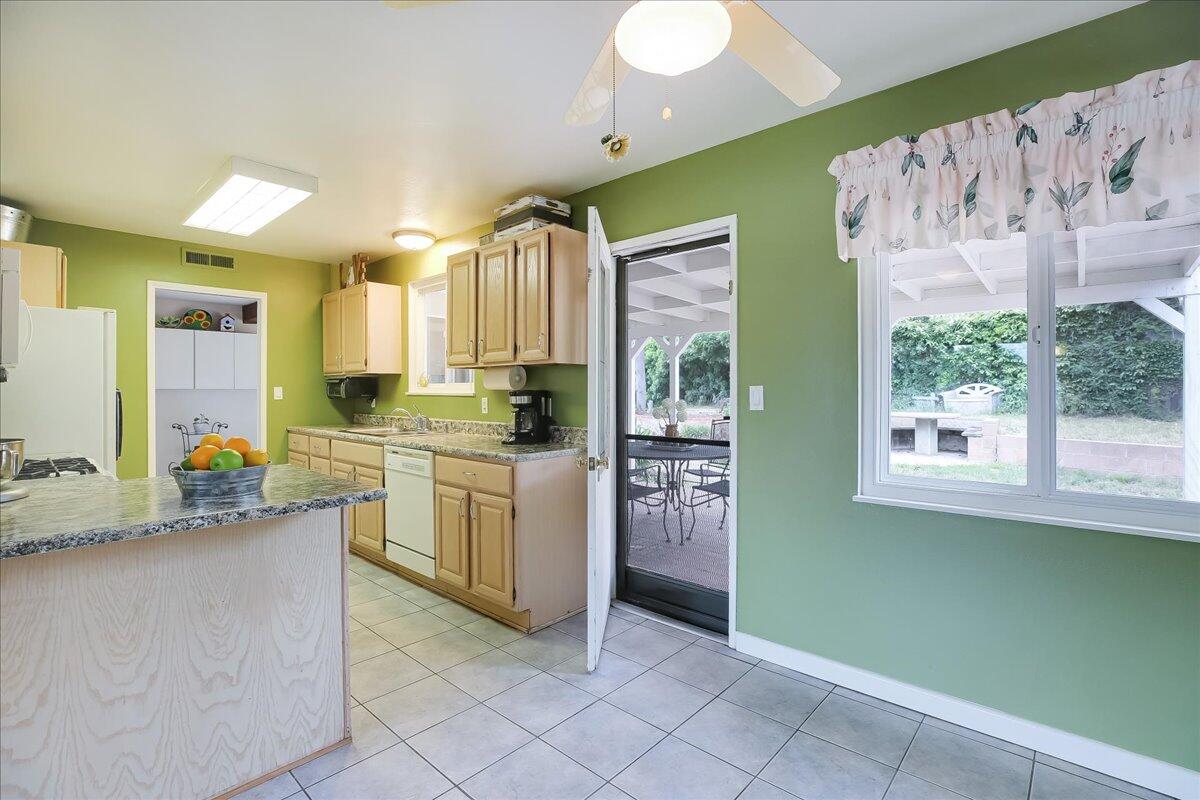 77 Newcastle Circle Goleta, CA 93117 - Photo 19 of 34 a kitchen with granite countertop a stove a sink and a refrigerator