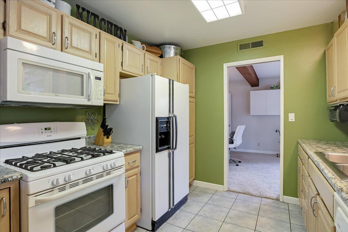 77 Newcastle Circle Goleta, CA 93117 - Photo 21 of 34 a kitchen with a stove top oven and refrigerator