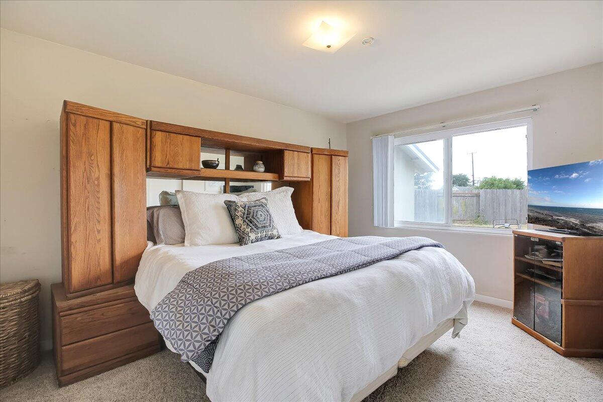 77 Newcastle Circle Goleta, CA 93117 - Photo 29 of 34 a bedroom with a large bed and a tv