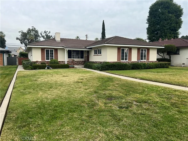 a front view of a house with a garden
