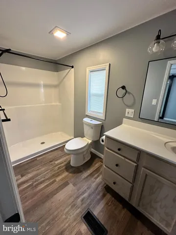 a bathroom with a double vanity sink a toilet and a mirror