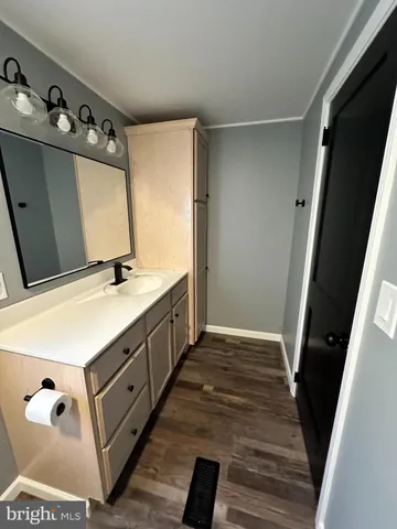 a bathroom with a double vanity sink and mirror