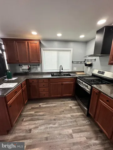 a kitchen with stainless steel appliances granite countertop a sink counter space and cabinets