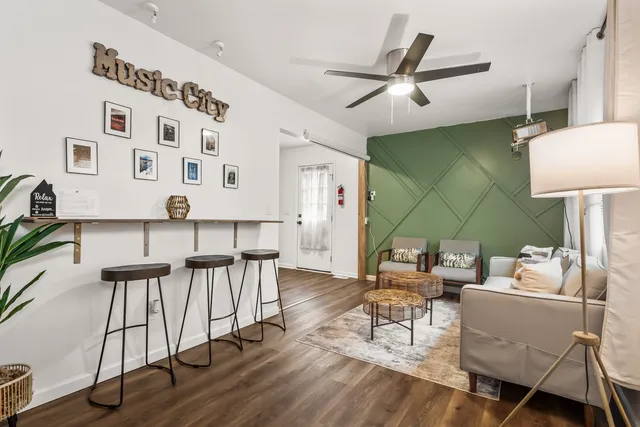 a living room with furniture and wooden floor