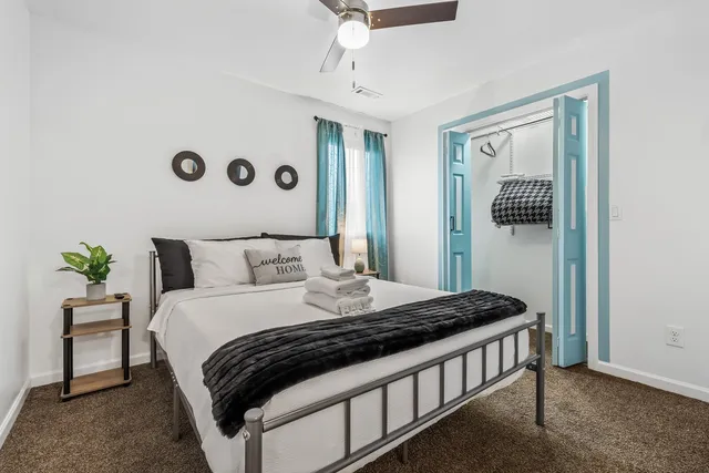 a bedroom with a bed and a window