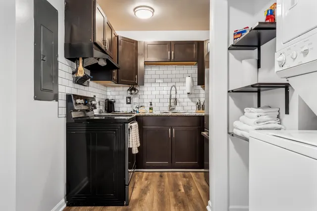 a kitchen with stainless steel appliances granite countertop a refrigerator and a sink