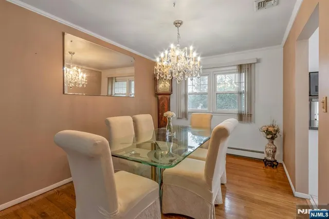 a view of a dining room with furniture and chandelier