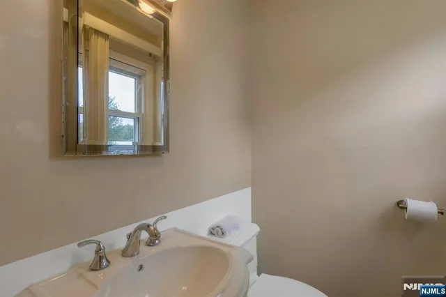 a bedroom with a bed a flat screen tv and dresser