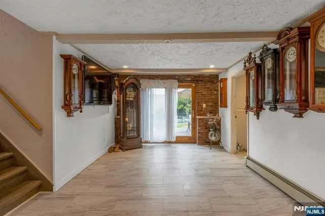 a view of a entryway door with hallway and wooden floor