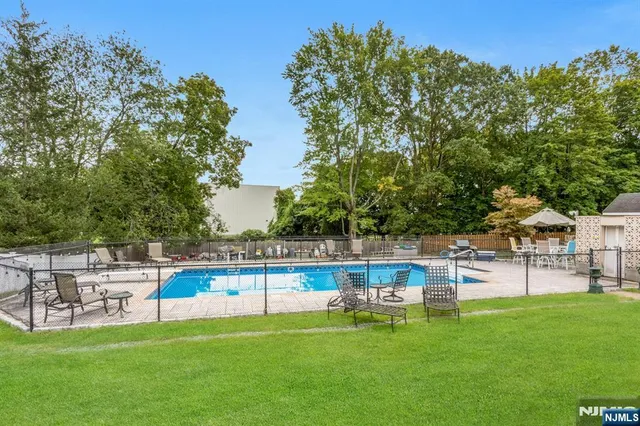 a view of a swimming pool with lounge chairs
