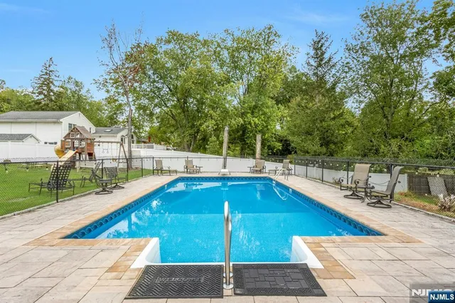 a view of swimming pool with outdoor seating and plants