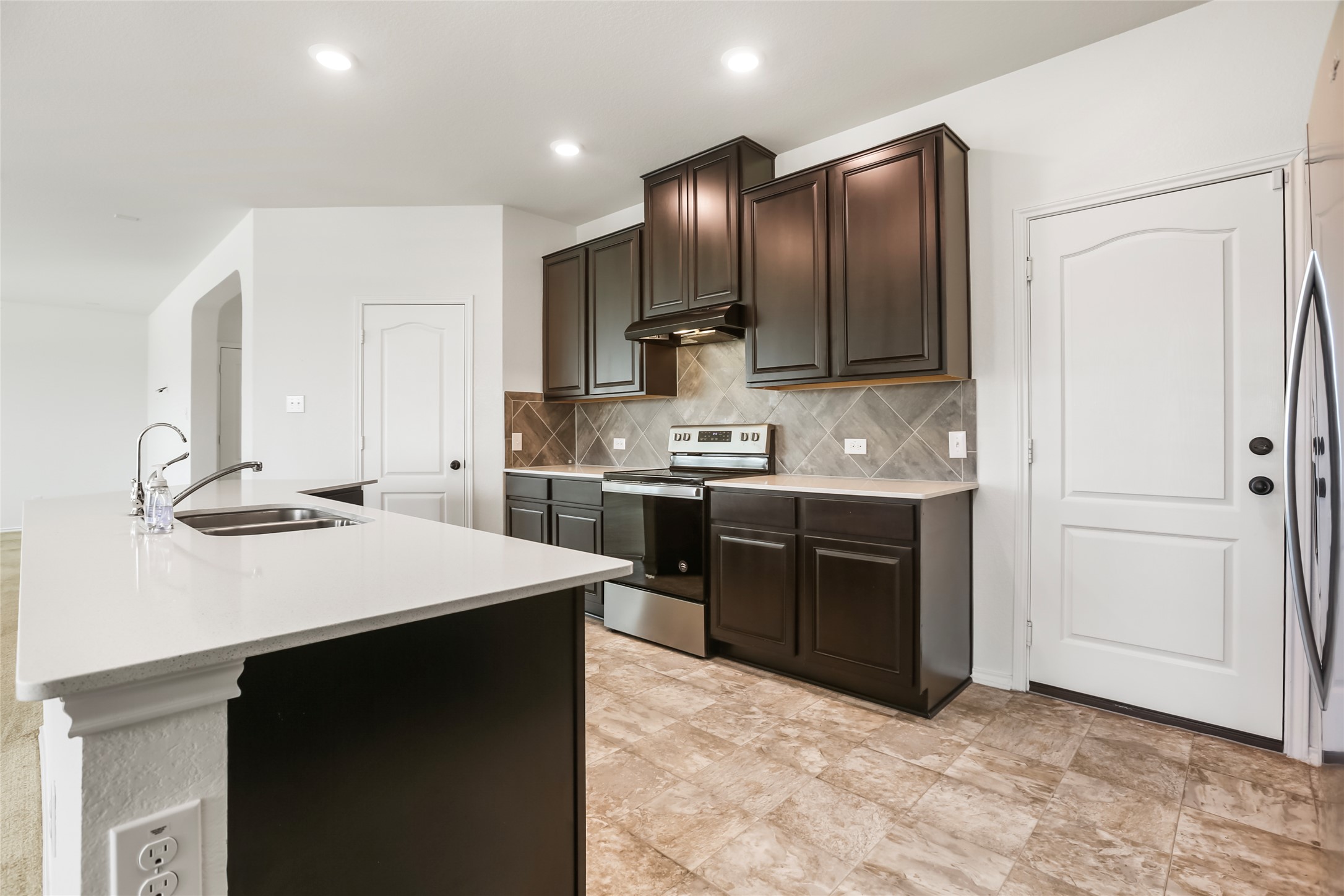 18917 Rushmore Street Manor, TX 78653 - Photo 7 of 28 a kitchen with a sink appliances and cabinets