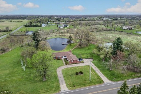 8675 West Smith Road Medina, OH 44256 - Photo 25 of 25 Expansive property featuring a private pond with a dock, mature trees, and a red brick ranch-style home