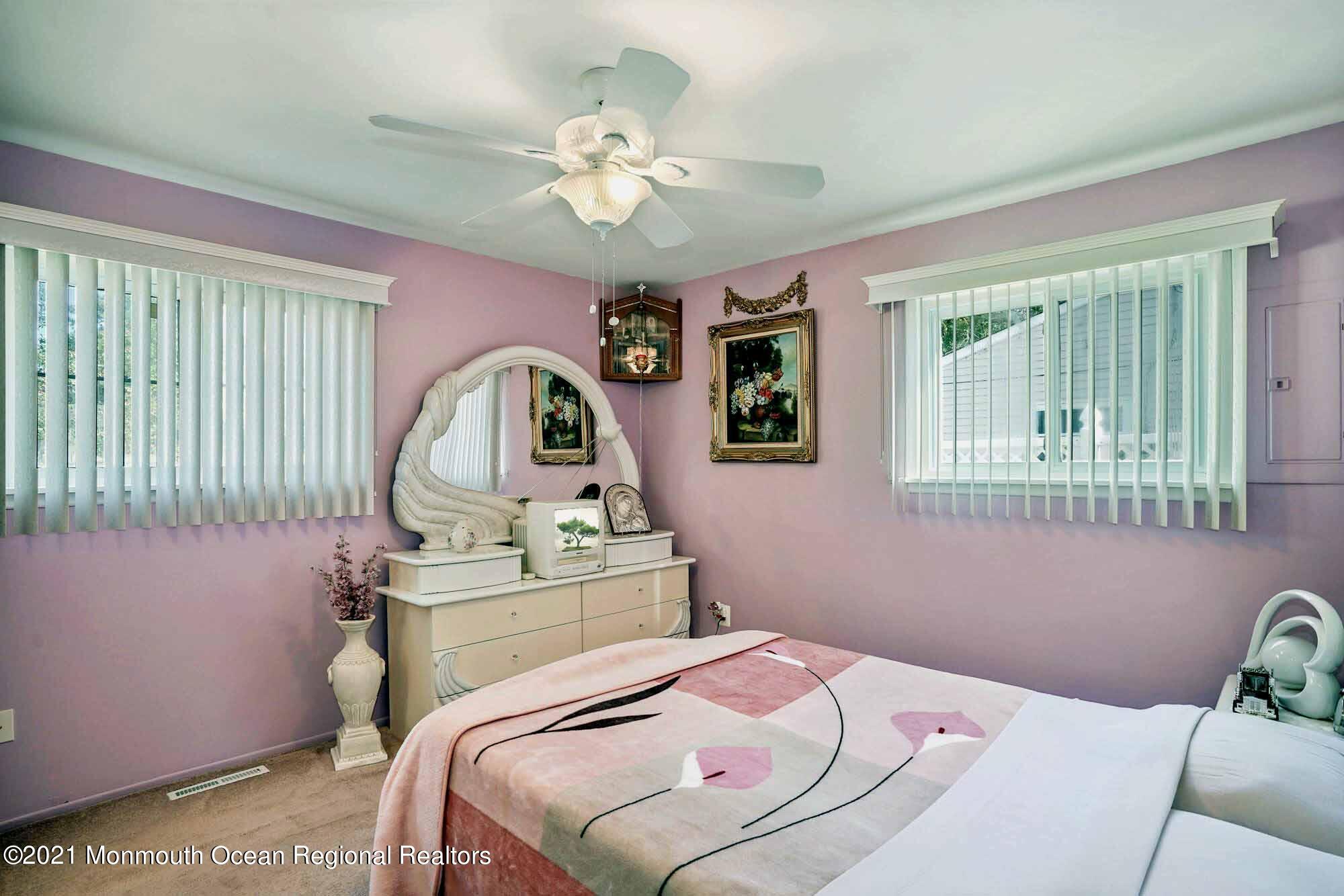 451 Alfred Road Toms River, NJ 08757 - Photo 14 of 25 a bedroom with a bed and a chandelier