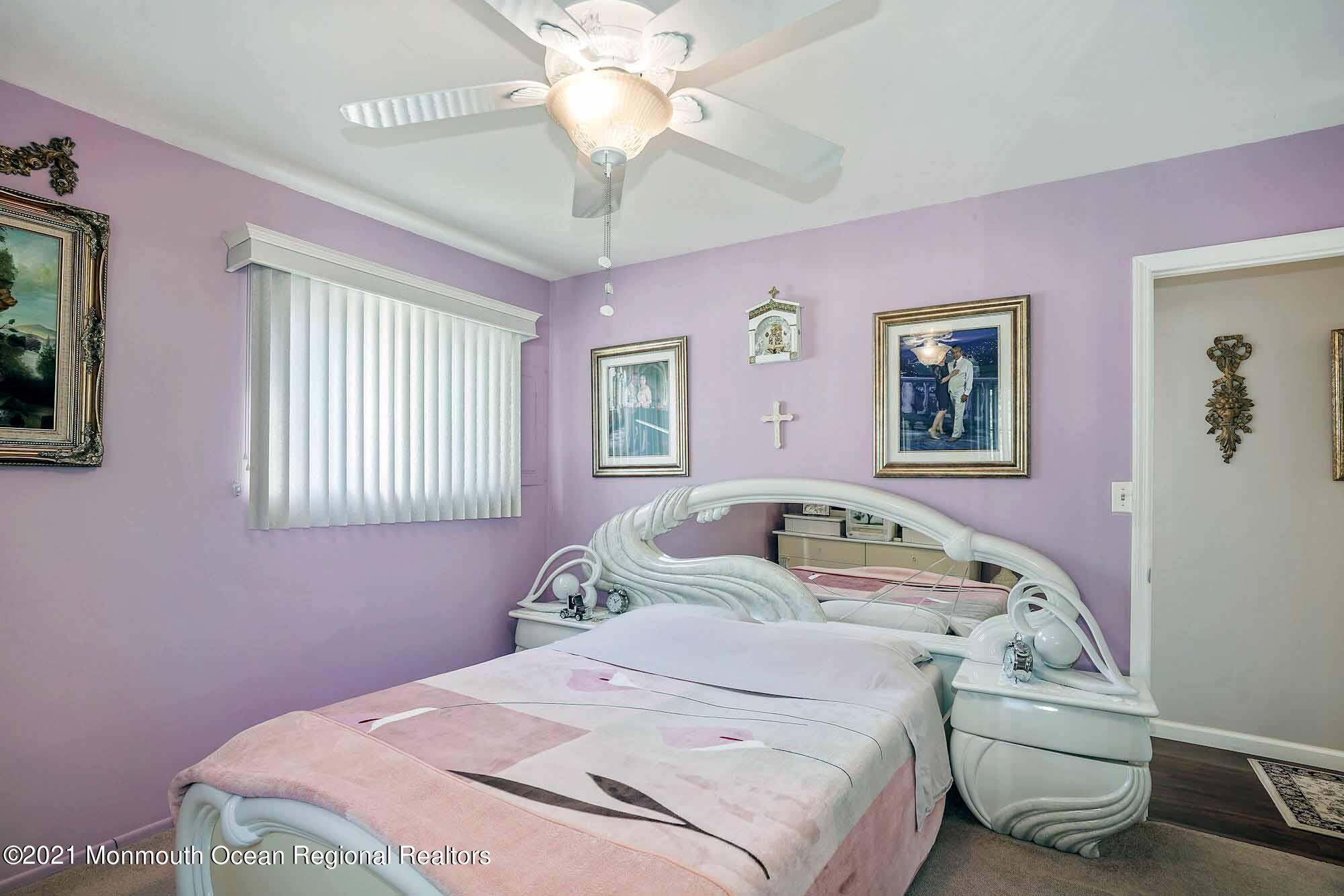 451 Alfred Road Toms River, NJ 08757 - Photo 15 of 25 a bedroom with a bed and a chandelier