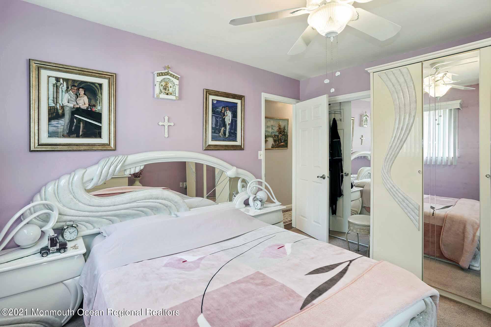 451 Alfred Road Toms River, NJ 08757 - Photo 16 of 25 a bedroom with a bed and a chandelier