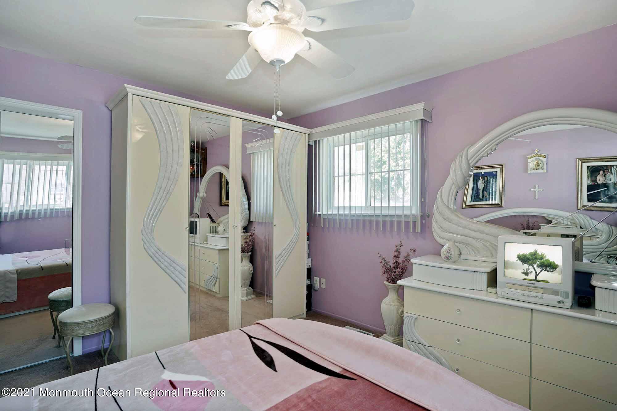 451 Alfred Road Toms River, NJ 08757 - Photo 17 of 25 a bedroom with a bed and a chandelier