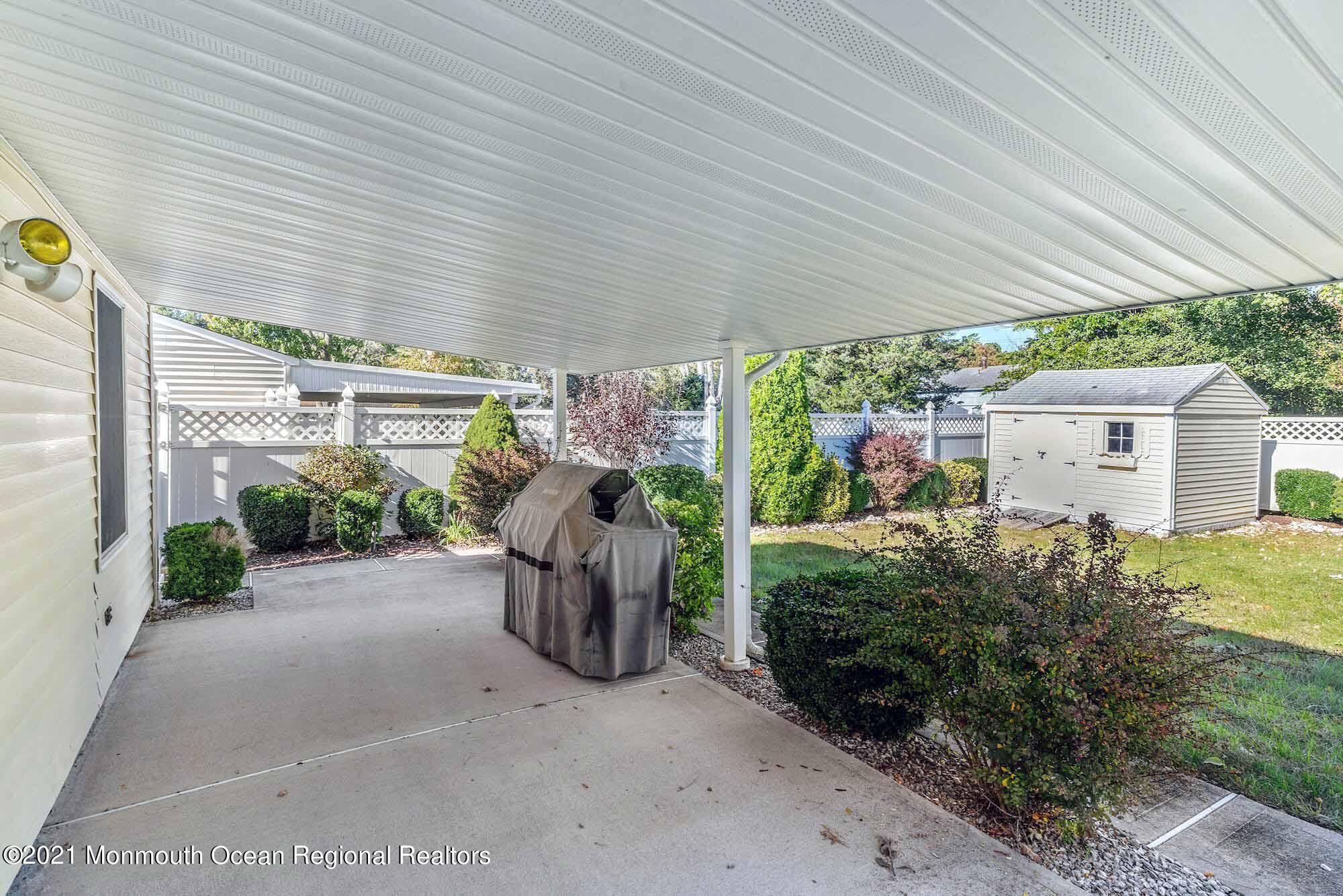 451 Alfred Road Toms River, NJ 08757 - Photo 21 of 25 a view of a patio with table and chairs under an umbrella