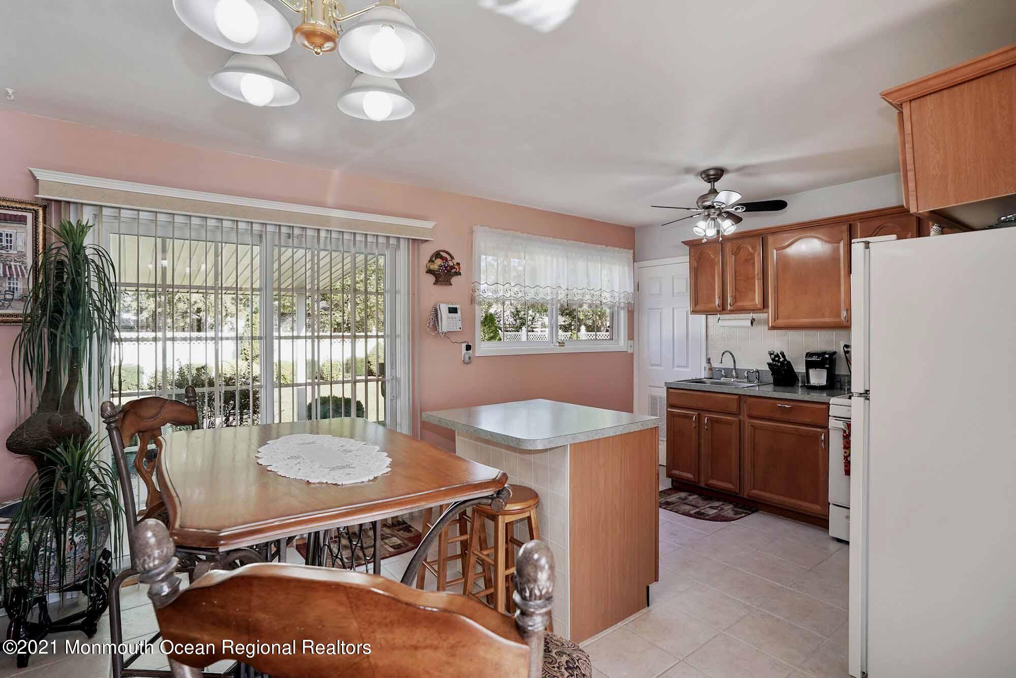 451 Alfred Road Toms River, NJ 08757 - Photo 5 of 25 a kitchen with sink a stove and chairs