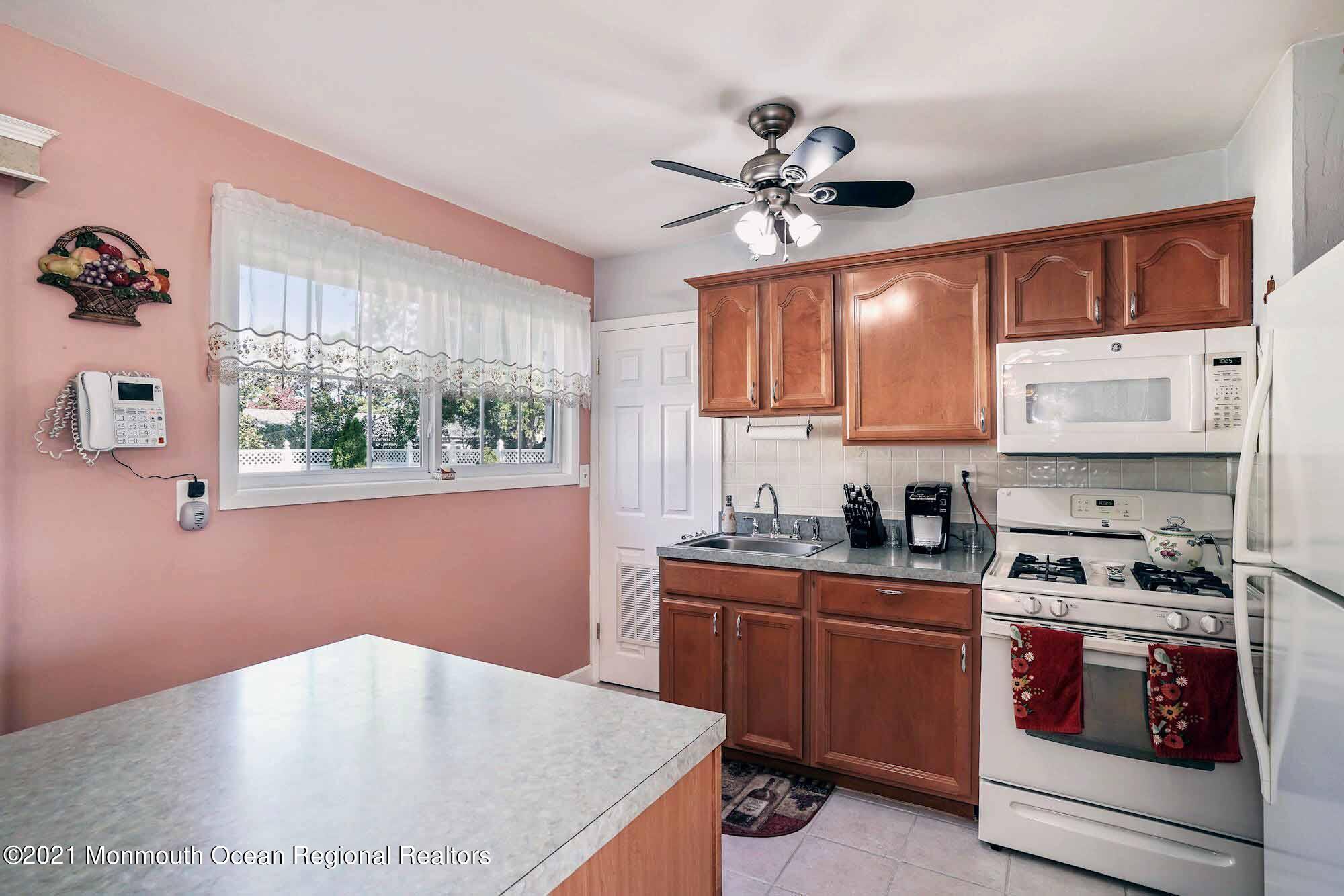 451 Alfred Road Toms River, NJ 08757 - Photo 6 of 25 a kitchen with kitchen island a sink cabinets and window