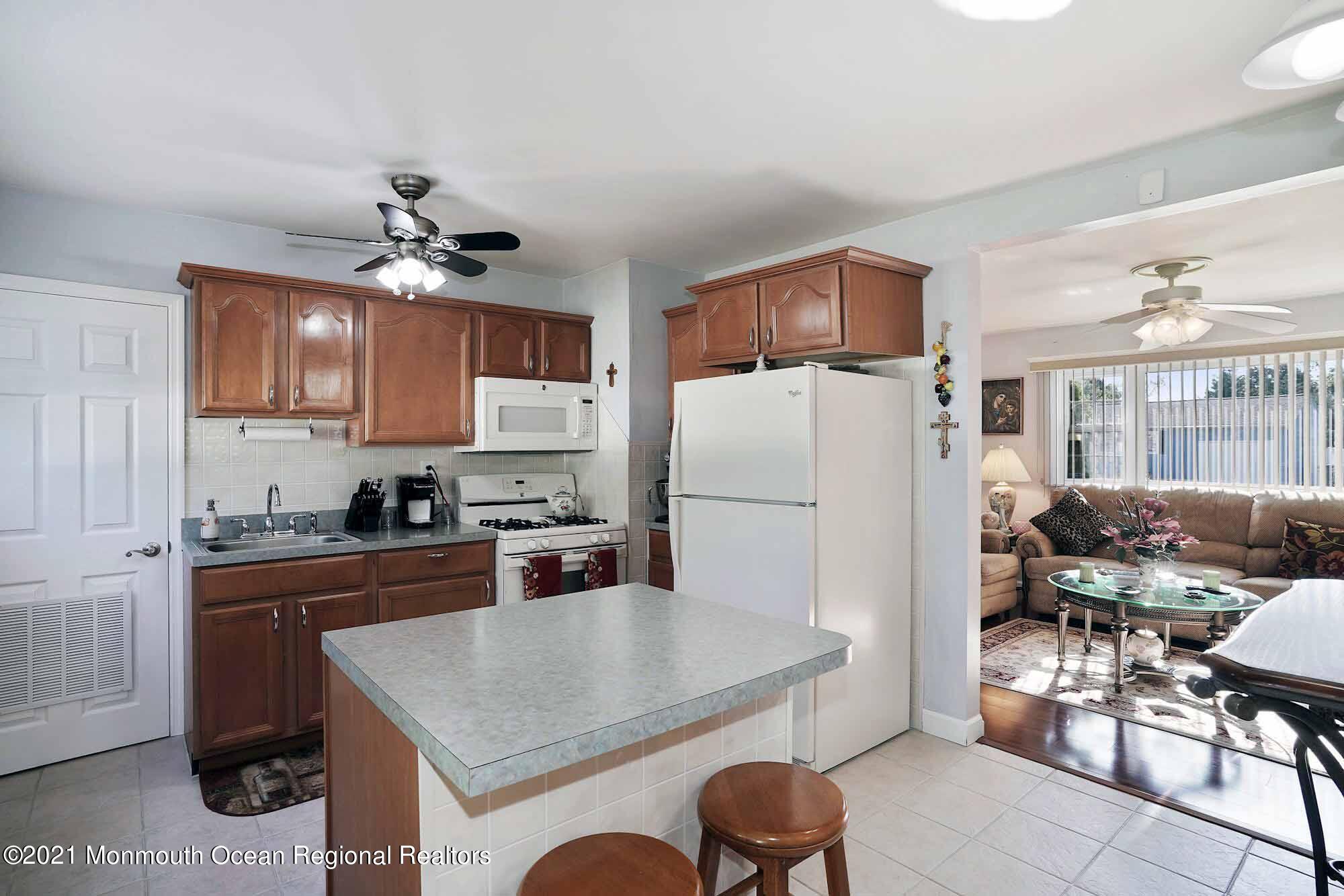 451 Alfred Road Toms River, NJ 08757 - Photo 7 of 25 a kitchen with furniture a refrigerator and chairs