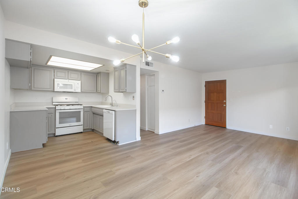 a kitchen with a stove a sink and a refrigerator