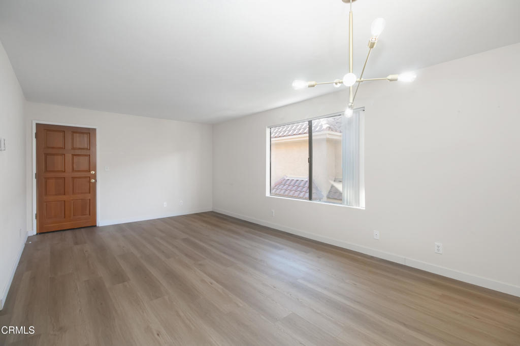1169 Rosedale Avenue, Unit 208 Glendale, CA 91201 - Photo 3 of 20 an empty room with wooden floor and windows