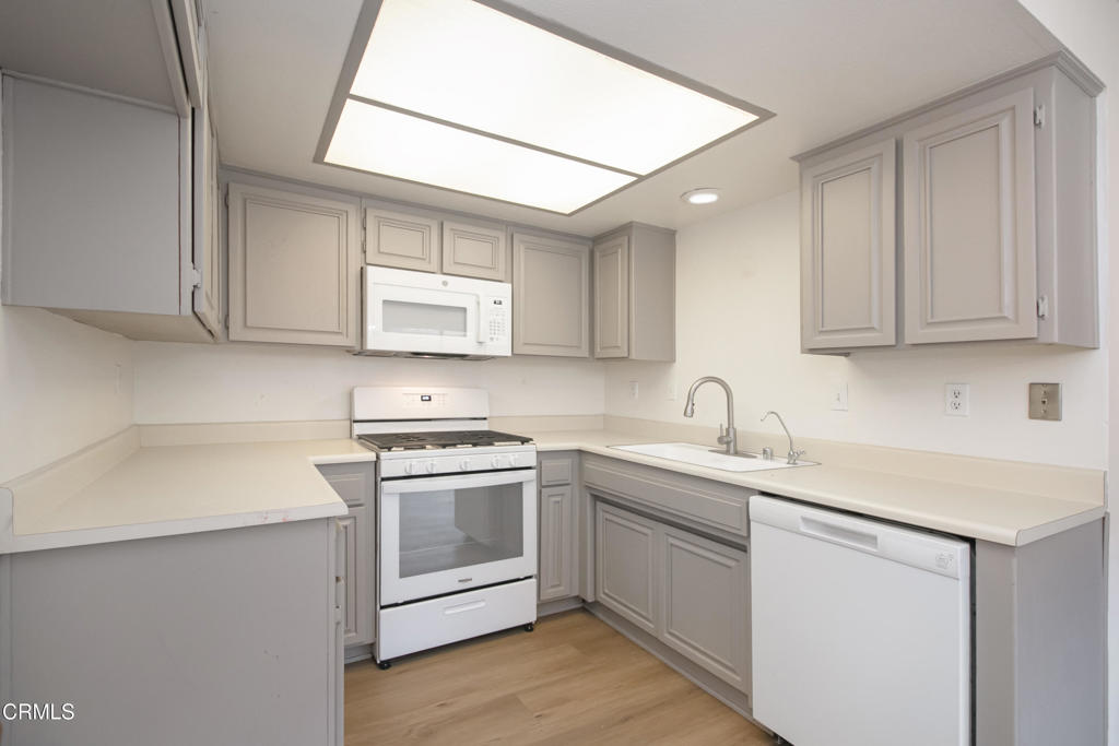 1169 Rosedale Avenue, Unit 208 Glendale, CA 91201 - Photo 4 of 20 a kitchen with white cabinets appliances and a sink
