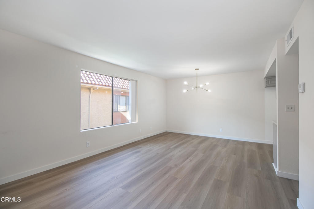 1169 Rosedale Avenue, Unit 208 Glendale, CA 91201 - Photo 7 of 20 an empty room with wooden floor and windows