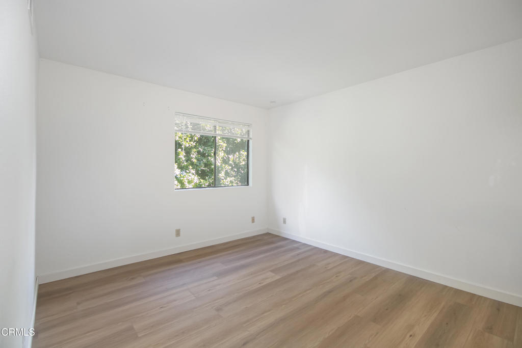 1169 Rosedale Avenue, Unit 208 Glendale, CA 91201 - Photo 10 of 20 an empty room with wooden floor and window