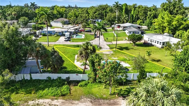 an aerial view of a house with a swimming pool yard and outdoor seating