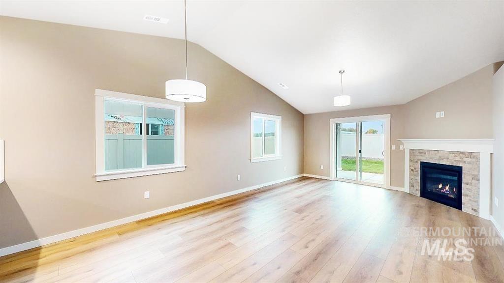 2432 Legacy Court Clarkston, WA 99403 - Photo 13 of 22 Unfurnished living room featuring lofted ceiling, wood finished floors, and a fireplace