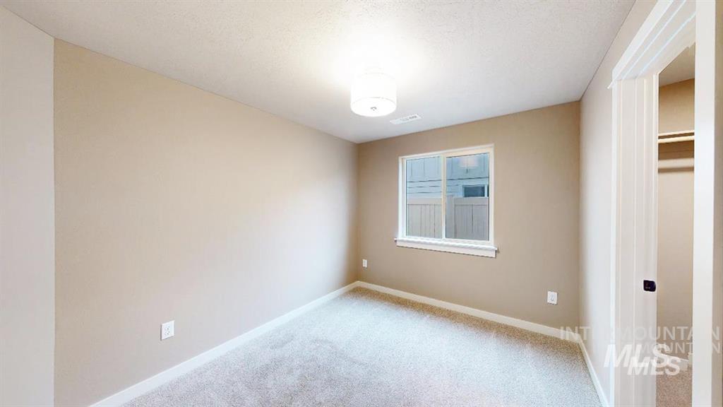 2432 Legacy Court Clarkston, WA 99403 - Photo 18 of 22 Unfurnished bedroom with carpet, a closet, and a textured ceiling