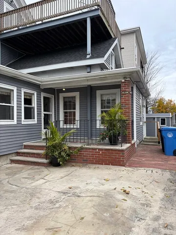 a view of a house with a patio and plants