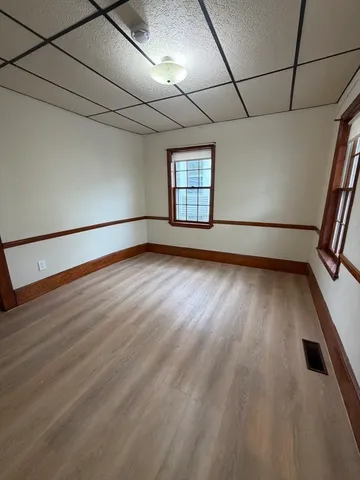 a view of empty room with wooden floor