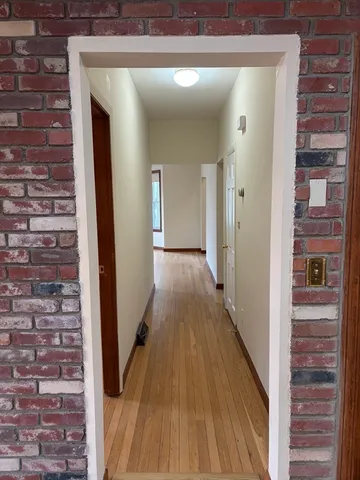 a view of an empty room and wooden floor