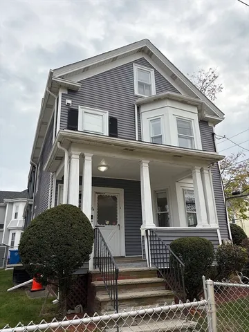 a front view of house with yard and outdoor seating
