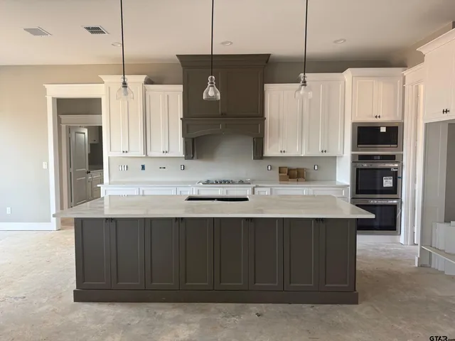 a kitchen with stainless steel appliances a sink stove and refrigerator