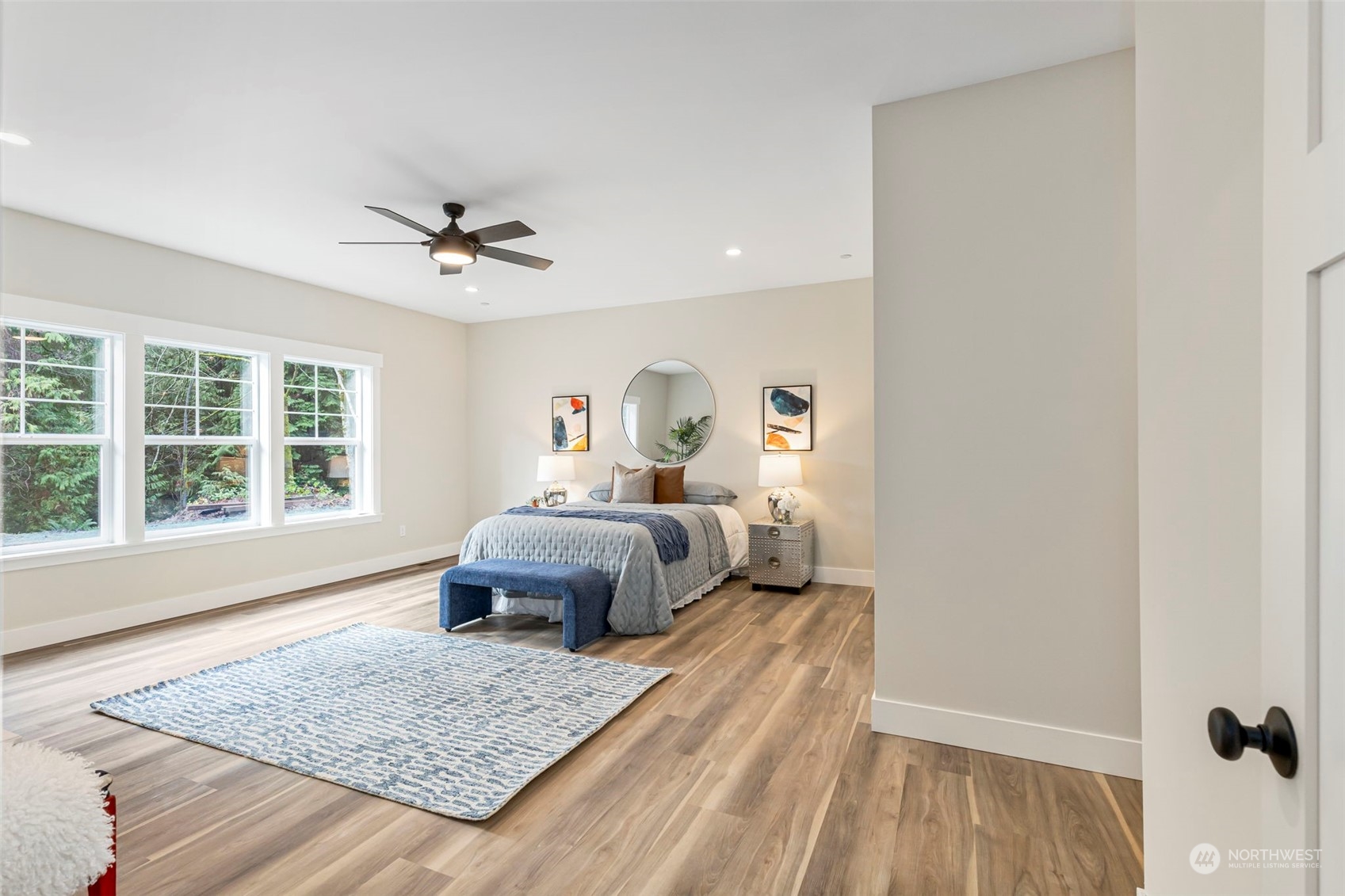 22086 Dewberry Road Northeast Indianola, WA 98342 - Photo 17 of 40 a bedroom with a large bed and a window