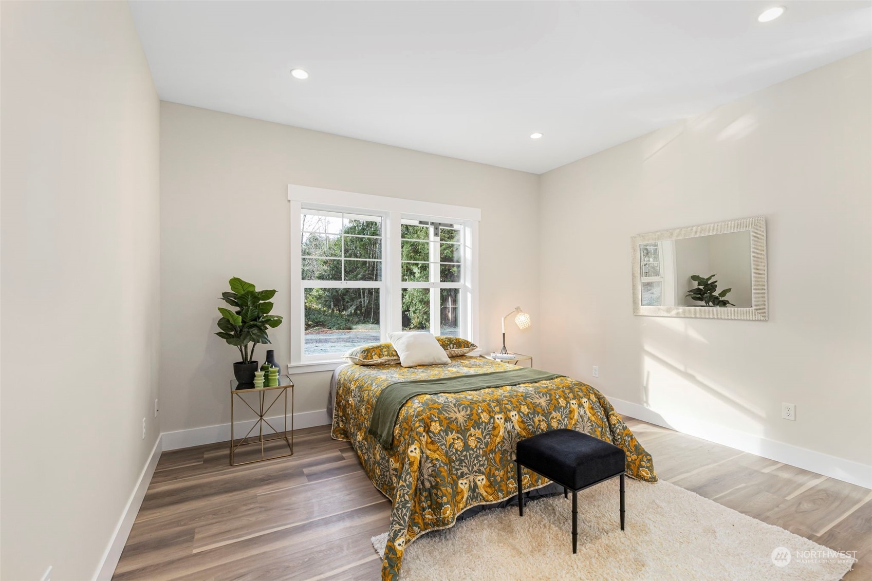 22086 Dewberry Road Northeast Indianola, WA 98342 - Photo 23 of 40 a bedroom with a bed and a potted plant