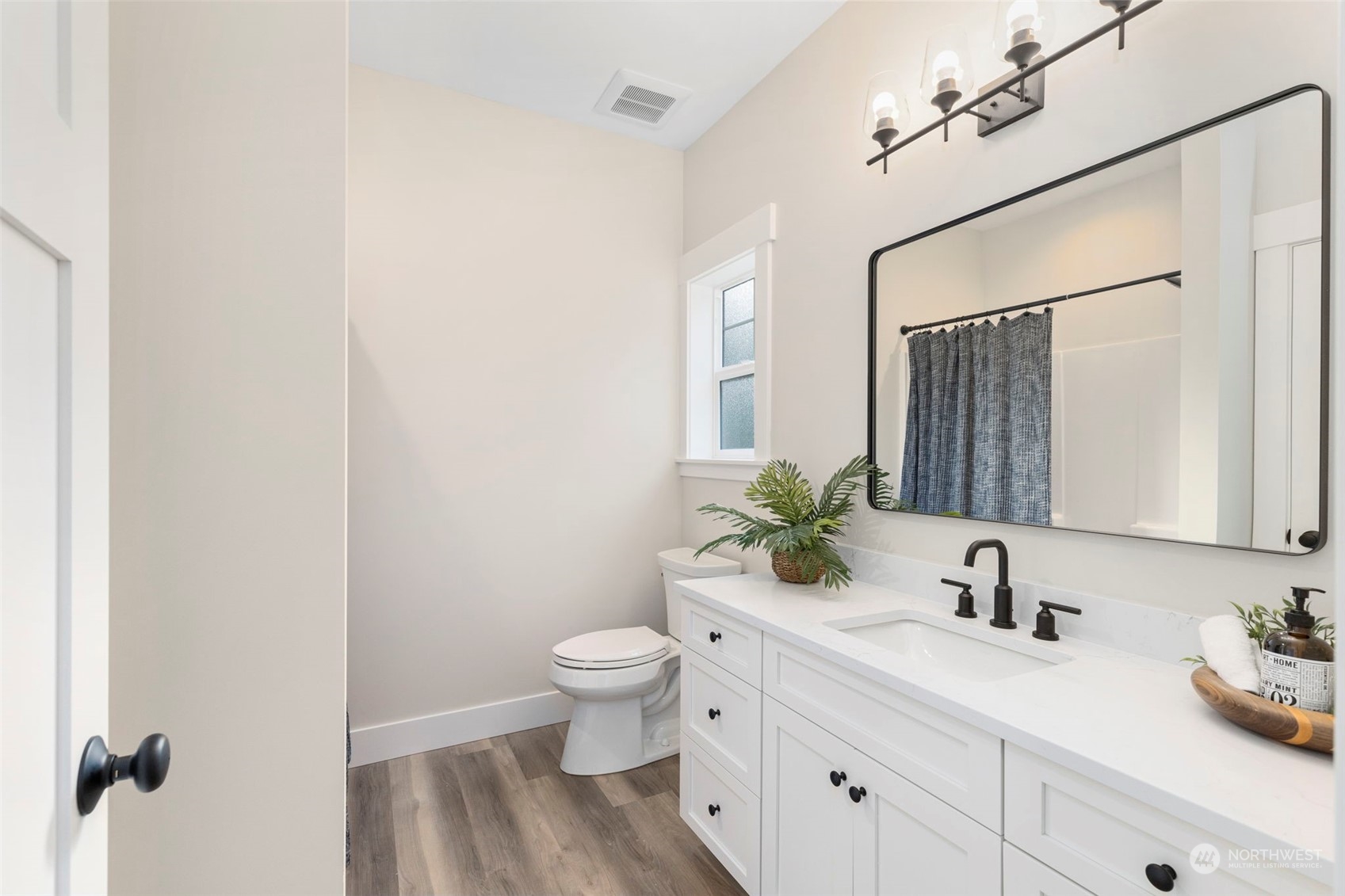 22086 Dewberry Road Northeast Indianola, WA 98342 - Photo 25 of 40 a bathroom with a toilet sink and mirror
