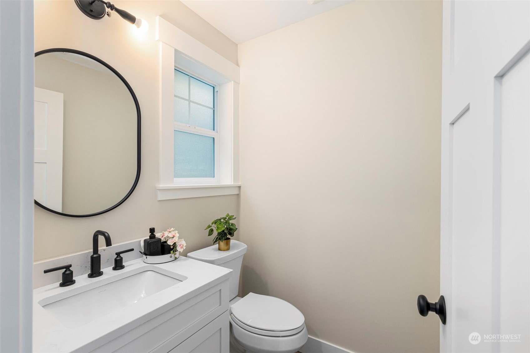 22086 Dewberry Road Northeast Indianola, WA 98342 - Photo 28 of 40 a bathroom with a sink a toilet and a mirror