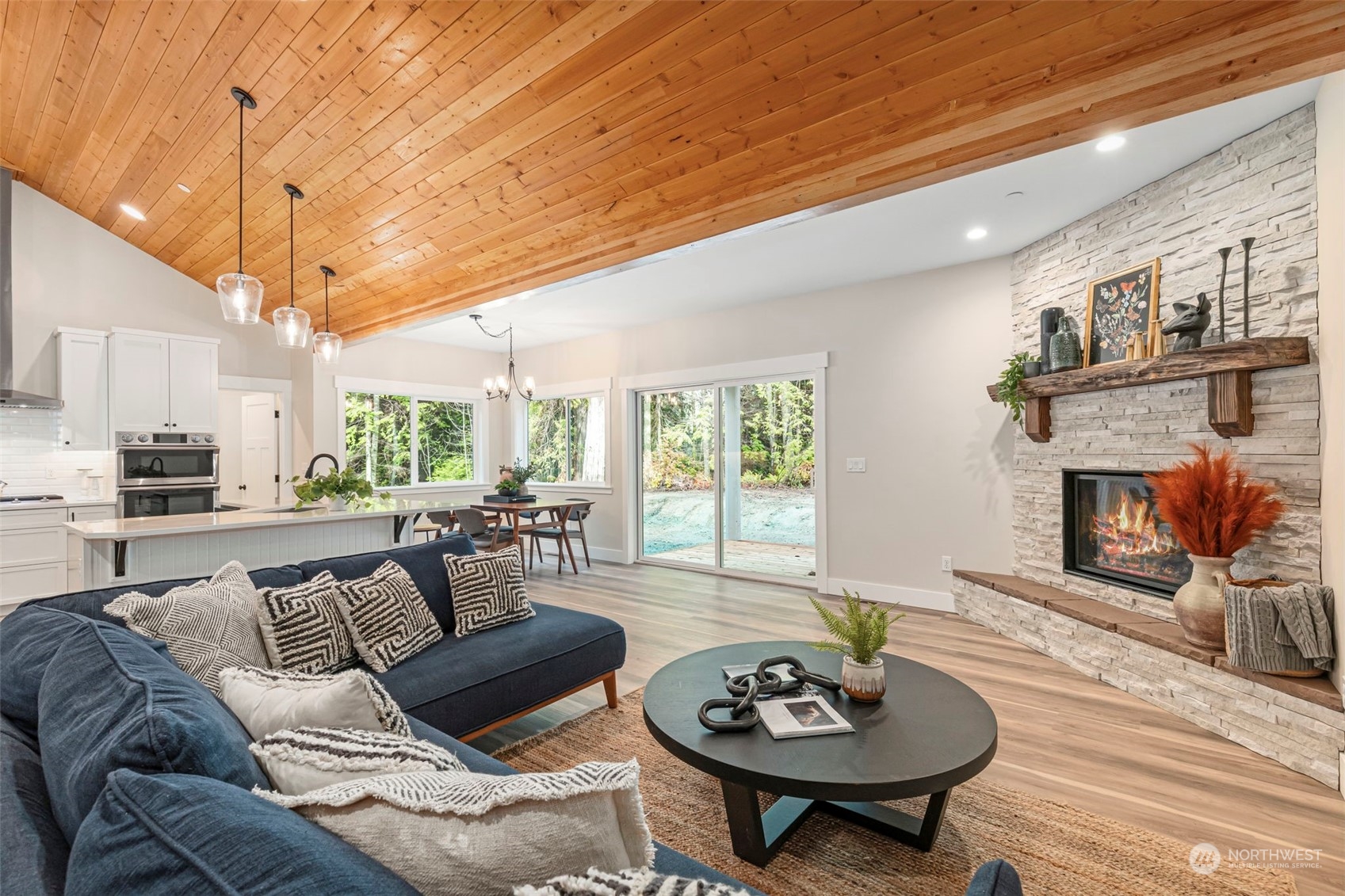 22086 Dewberry Road Northeast Indianola, WA 98342 - Photo 7 of 40 a living room with furniture and a fireplace
