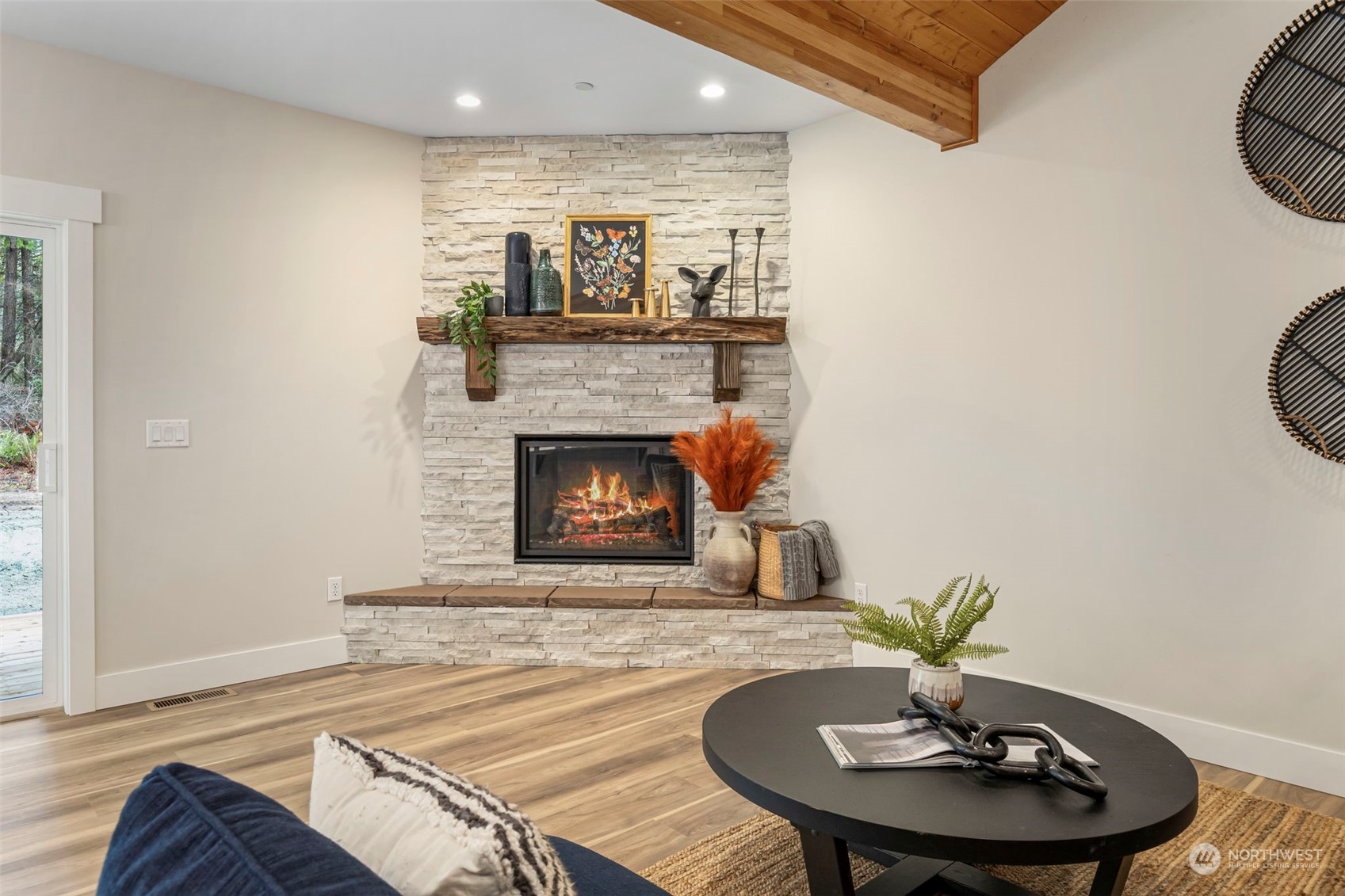 22086 Dewberry Road Northeast Indianola, WA 98342 - Photo 8 of 40 a living room with furniture and a fireplace