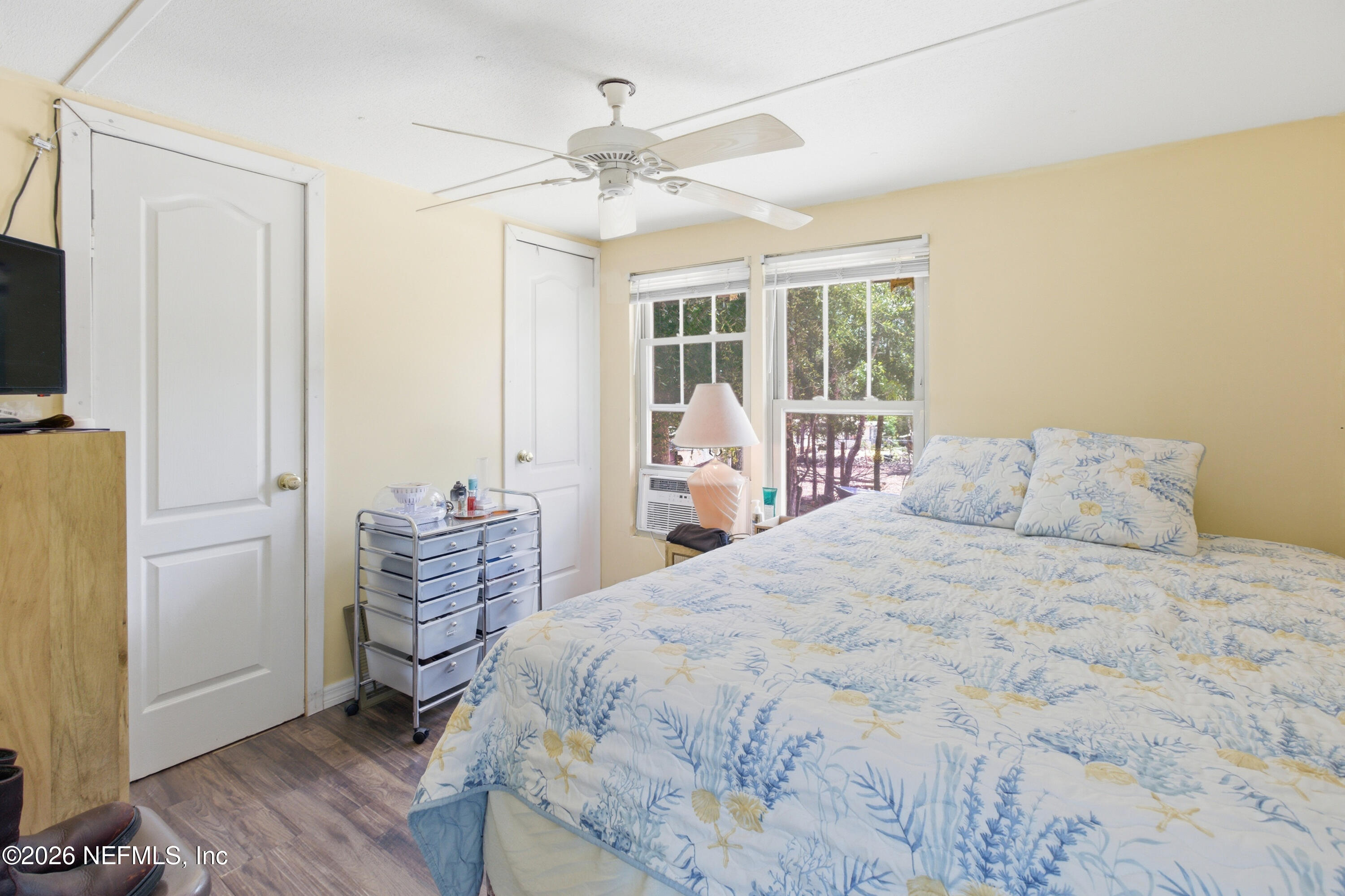 116 London Avenue Interlachen, FL 32148 - Photo 10 of 25 a bedroom with a bed and wooden floor