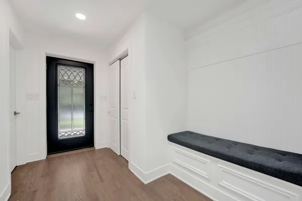 a view of a hallway with wooden floor